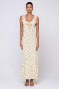 This is an image of Aimee Dress in Beurre - RESA featuring a model wearing the dress