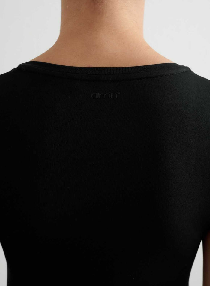 Musta Soft Basic V-neck Short Sleeve takaapäin, jossa on pehmeä kangas ja sävyyn sopiva aim'n-logo.