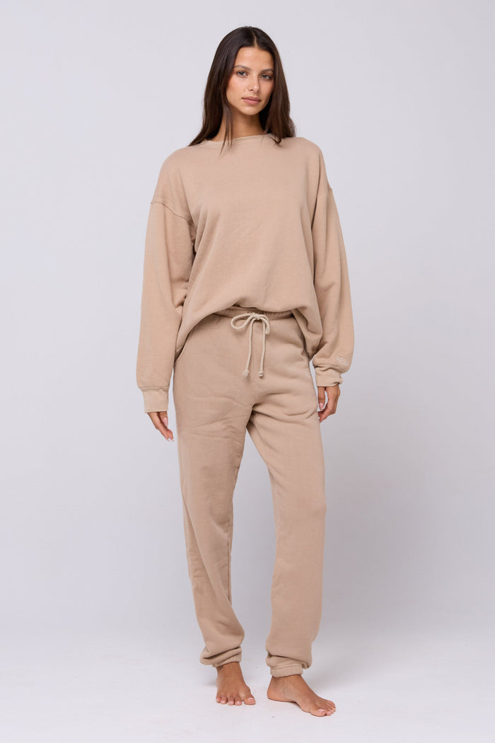 This is an image of Bodhi Sweatpants in Sand - RESA featuring a model wearing the dress