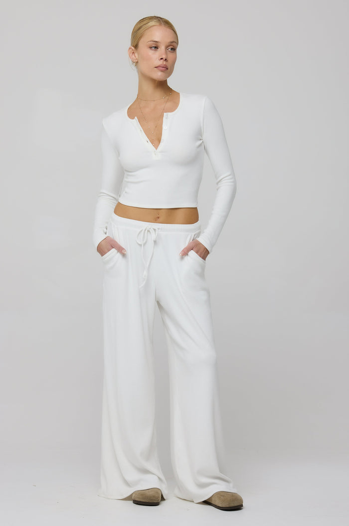 This is an image of Chase Rib Pant in White - RESA featuring a model wearing the dress