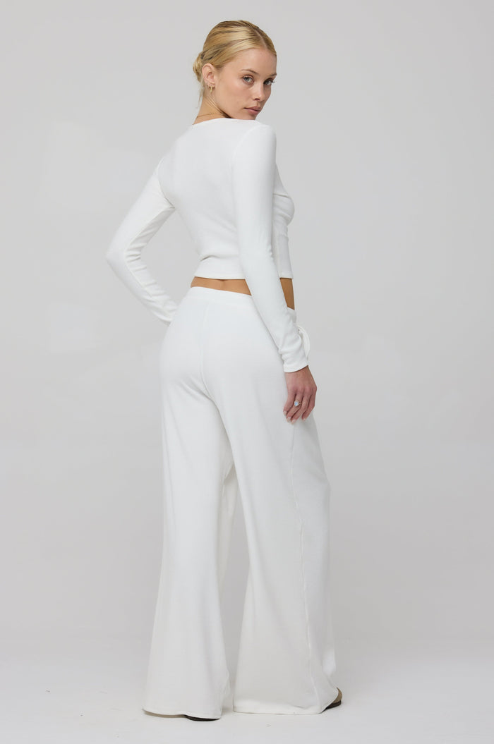 This is an image of Chase Rib Pant in White - RESA featuring a model wearing the dress