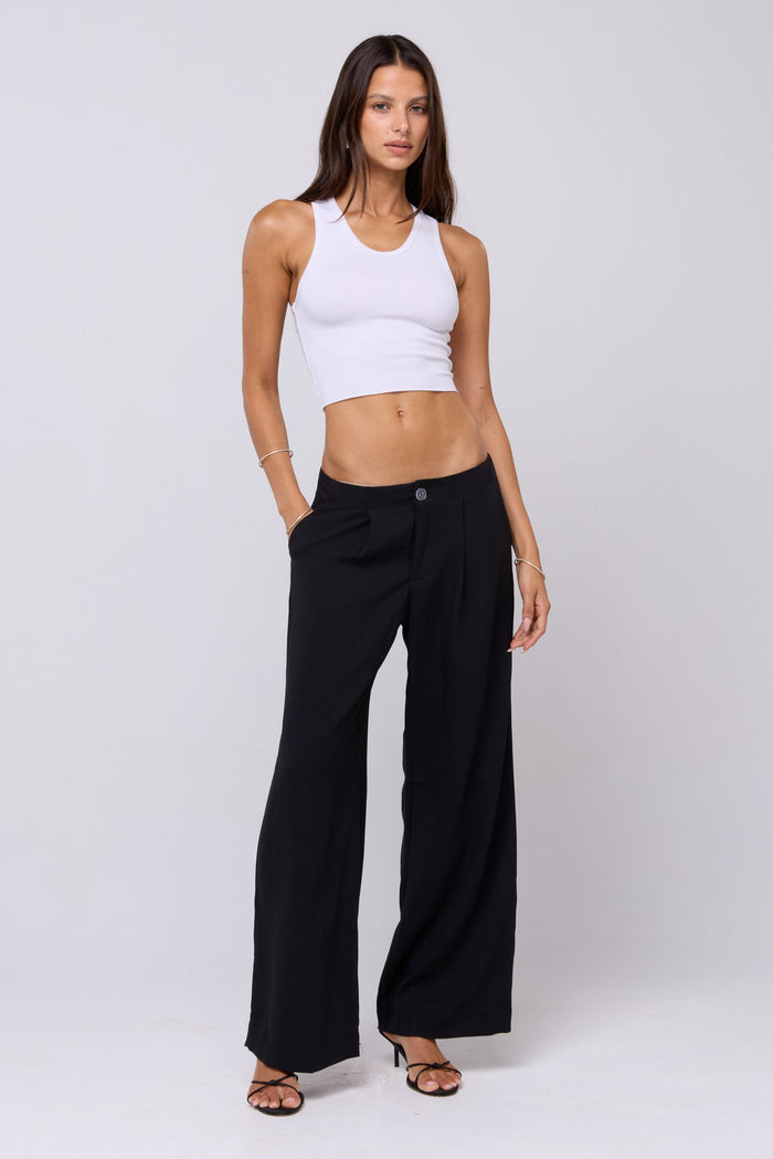This is an image of Malcolm Trousers in Black - RESA featuring a model wearing the dress
