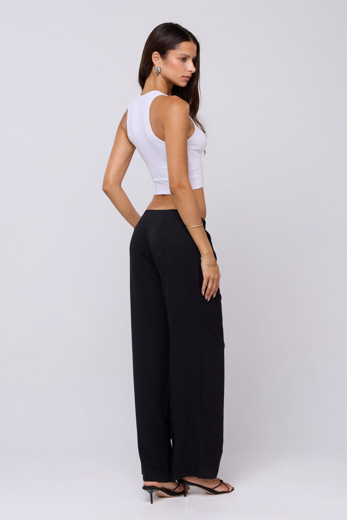 This is an image of Malcolm Trousers in Black - RESA featuring a model wearing the dress