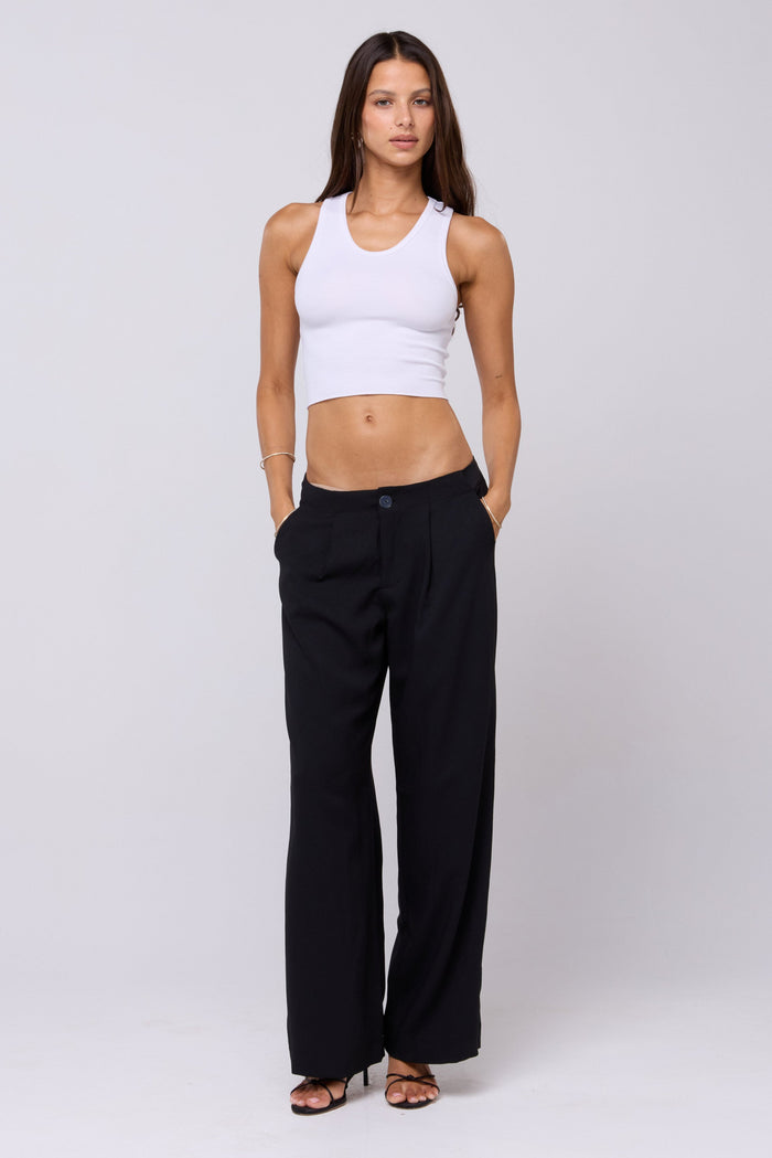 This is an image of Malcolm Trousers in Black - RESA featuring a model wearing the dress
