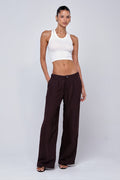 This is an image of Malcolm Trousers in Brown Linen - RESA featuring a model wearing the dress