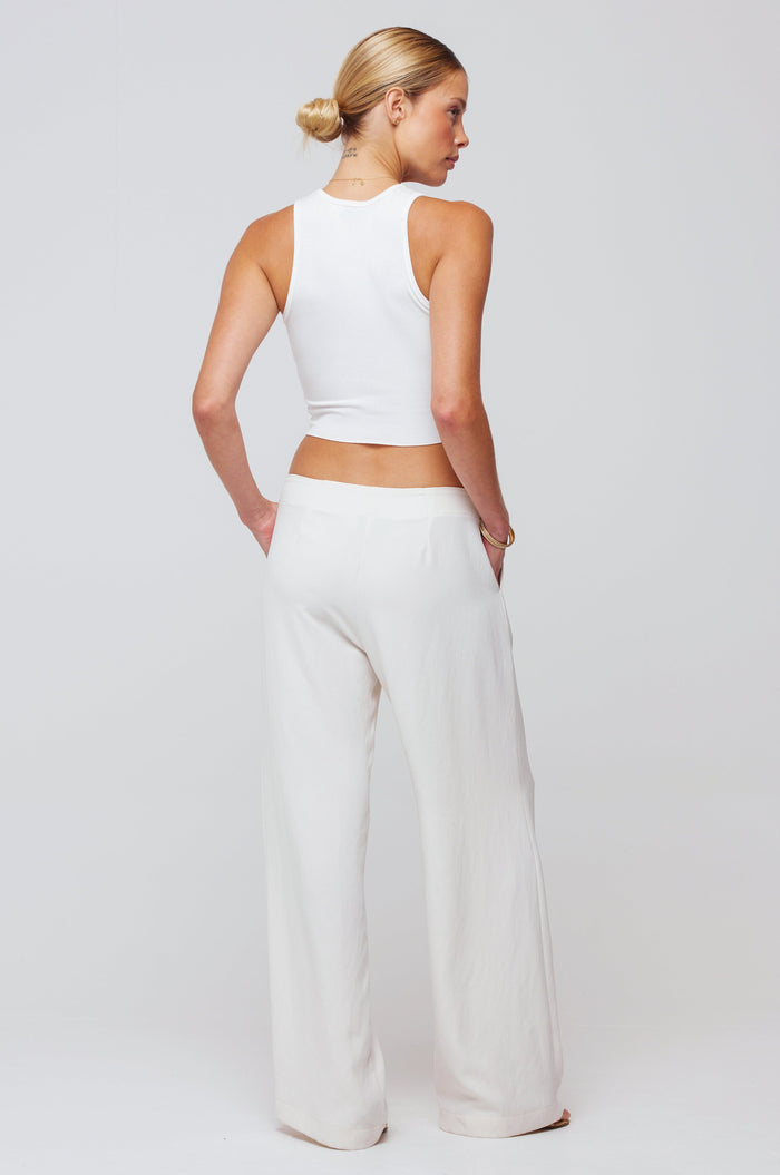 This is an image of Malcolm Trousers in Cream - RESA featuring a model wearing the dress