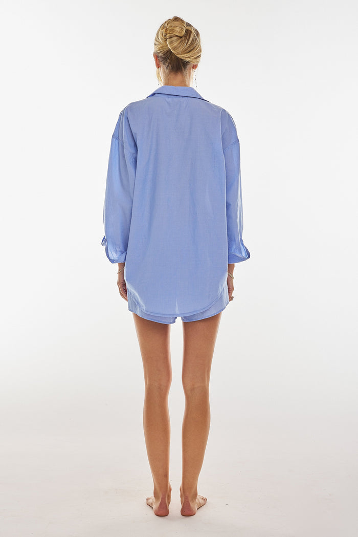 This is an image of Monica Blouse in Sky - RESA featuring a model wearing the dress