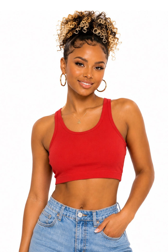 A woman modeling a bright red scoop-neck crop top with light blue jeans against a plain white background.
