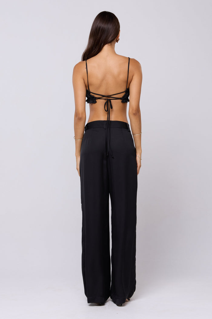 This is an image of Sasha Trouser in Black - RESA featuring a model wearing the dress