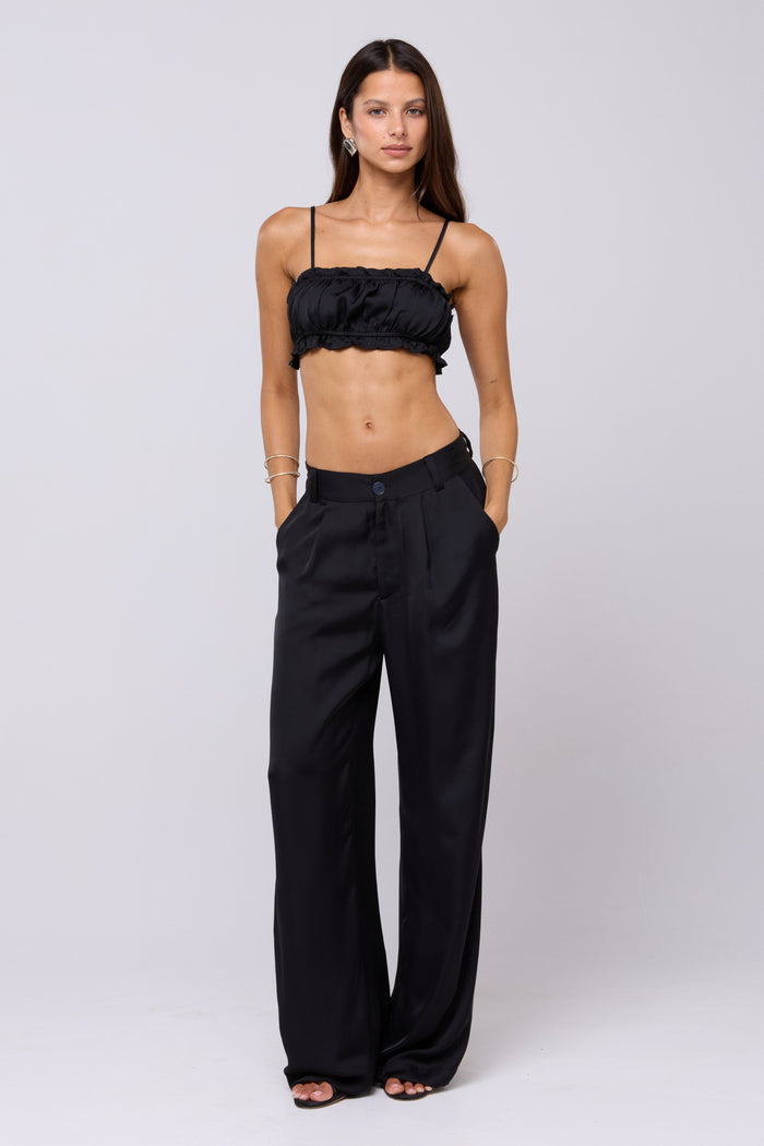 This is an image of Sasha Trouser in Black - RESA featuring a model wearing the dress