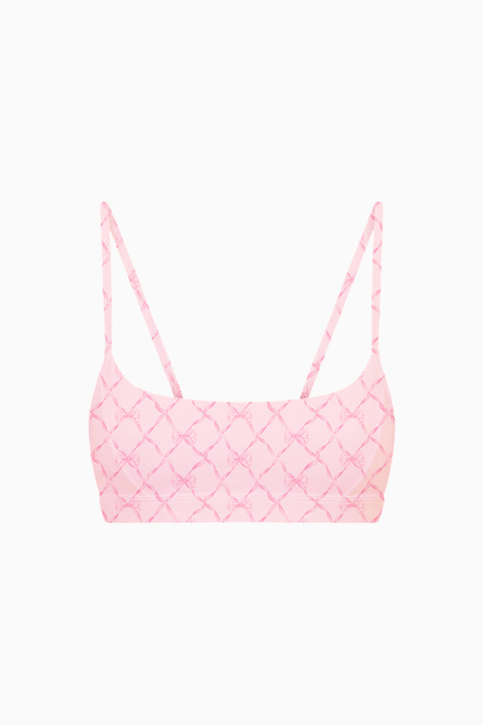 Pink bow patterned sports bra top on a white background
