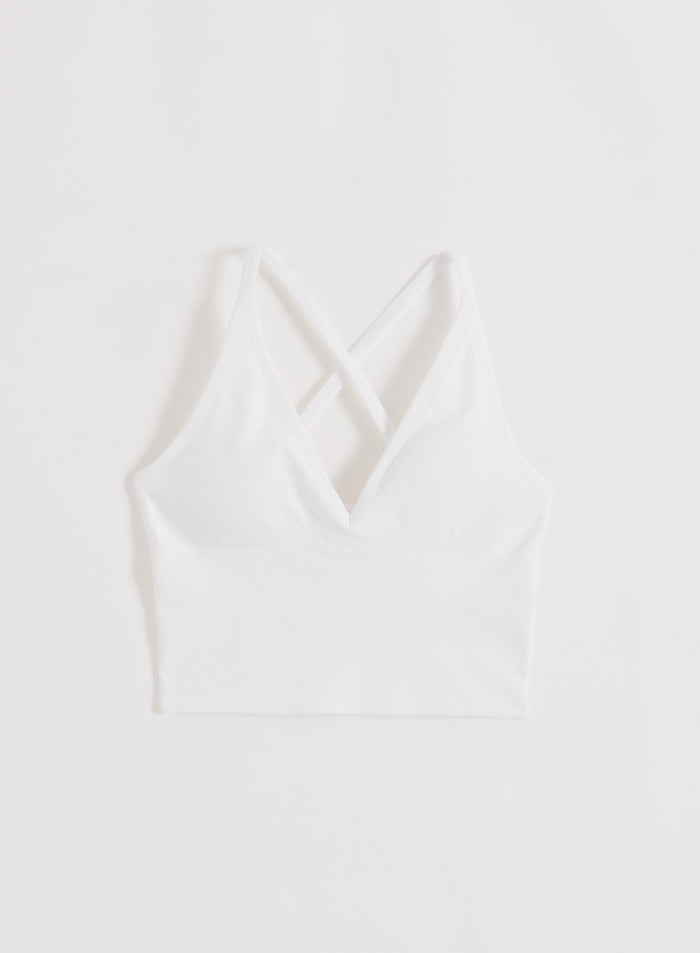 Valkoinen aim'n Shape Seamless Cross Back Bralette, jossa on V-pääntie, ribatut yksityiskohdat ja ristiin menevä selkämys.