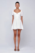 This is an image of Winnie Mini in White Linen - RESA featuring a model wearing the dress