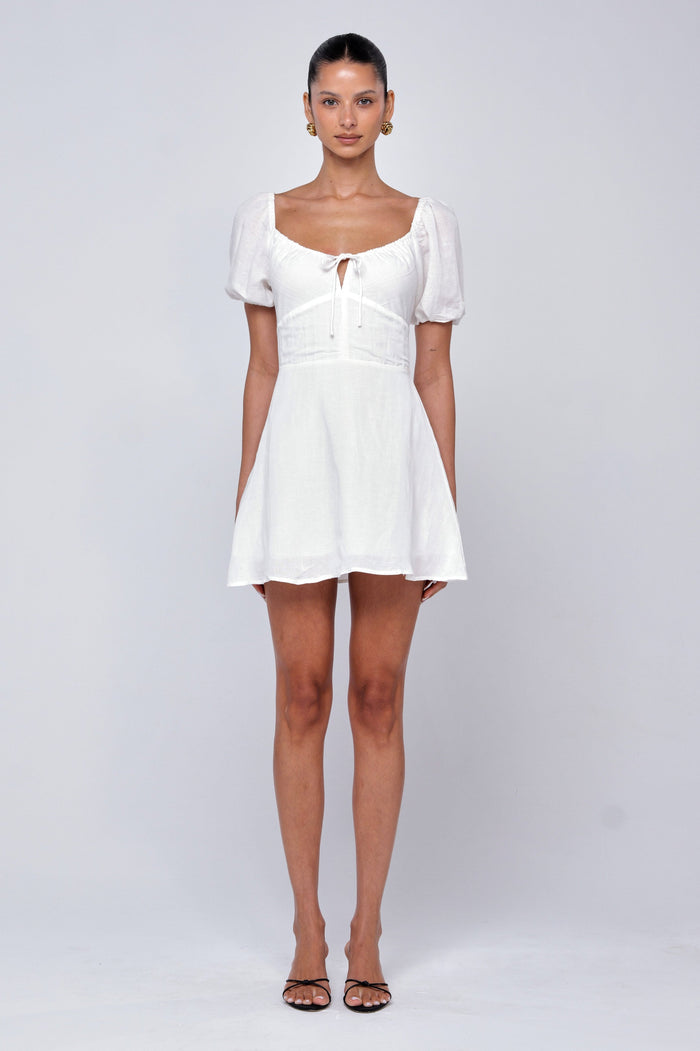 This is an image of Winnie Mini in White Linen - RESA featuring a model wearing the dress